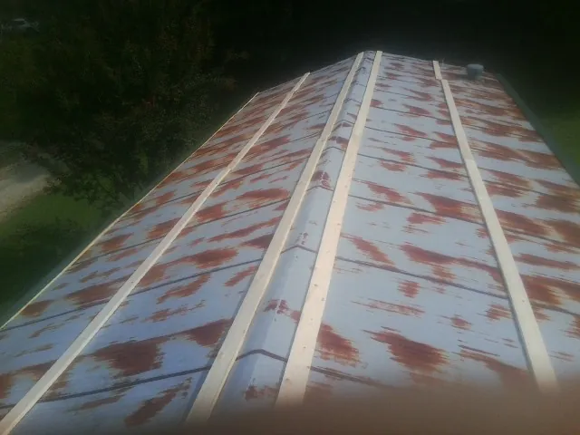 Rusted metal roof panels with new wood purlins before replacement — Storm Damage Roof Repair in Denhoff by Roofing Brothers
